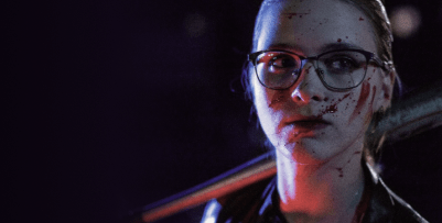 A young woman with blood splattered on her face is resting a baseball bat on her shoulder, looking intently to her left.